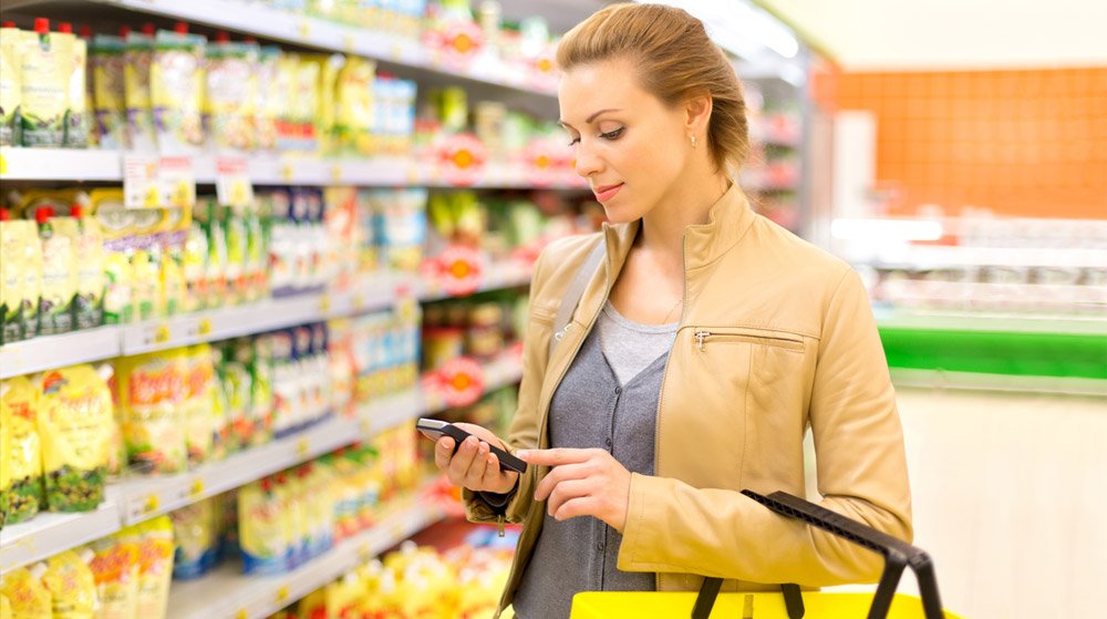 Shopper at supermarket aisle auditing