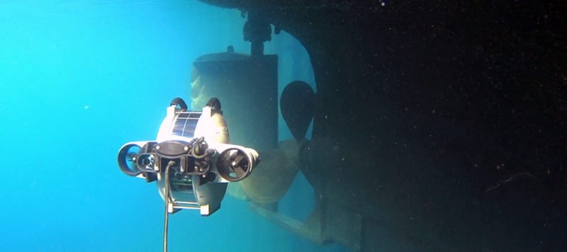 Underwater drones inspecting ship hull